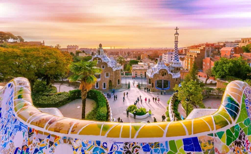 The famous mosaic benches at Park Güell at sunrise, a popular accessible attraction for accessible travel in Barcelona.