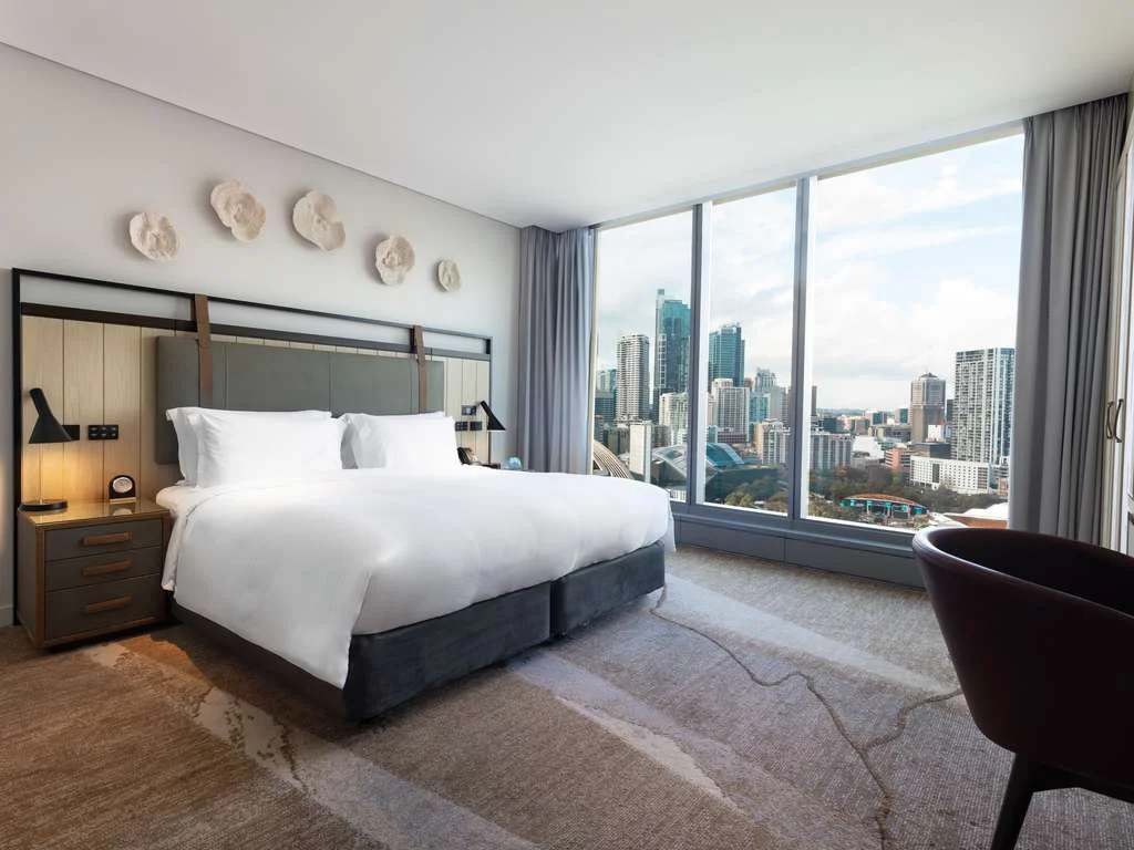 A spacious, modern room with a city view at the Sofitel Sydney Darling Harbour, a top choice for accessible travel in Sydney