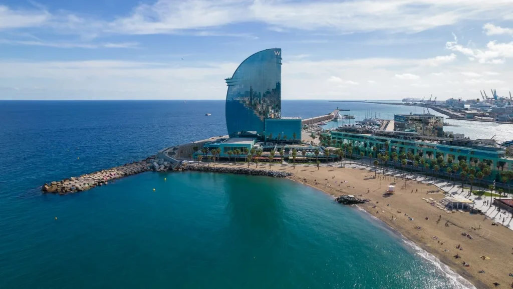 Aerial view of the iconic W Barcelona hotel on the beach, a luxury option for accessible travel in Barcelona.